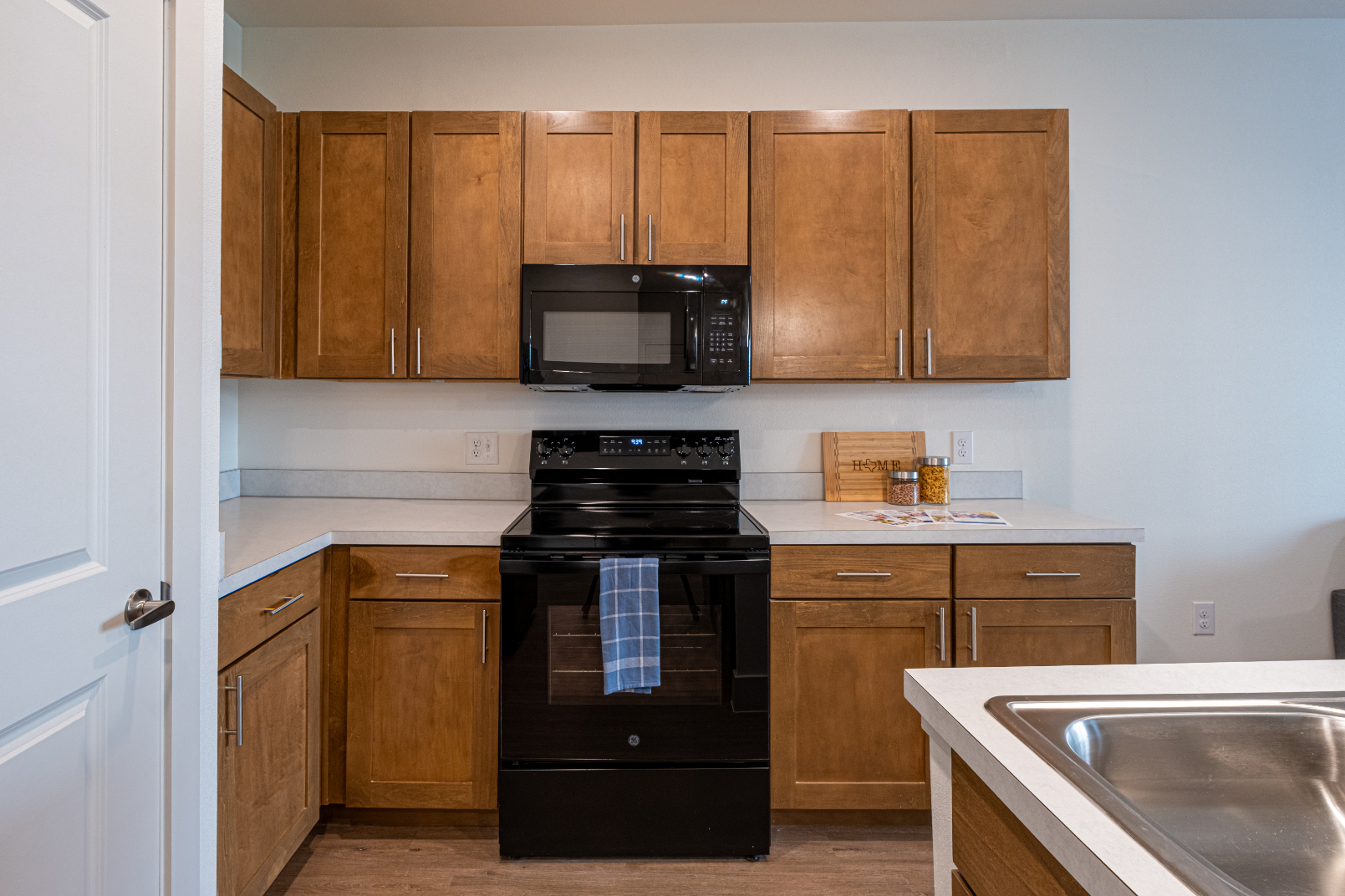 Kitchen with brown cabinets and black appliances