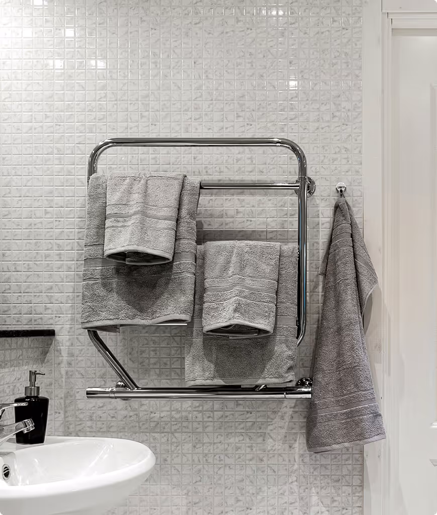 A bathroom with a sink and a towel rack.