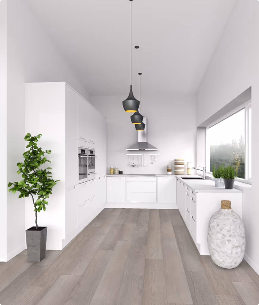 A white kitchen with a hanging light and a potted plant.