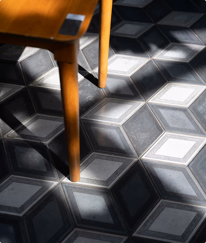A wooden chair with a black and white checkered floor.