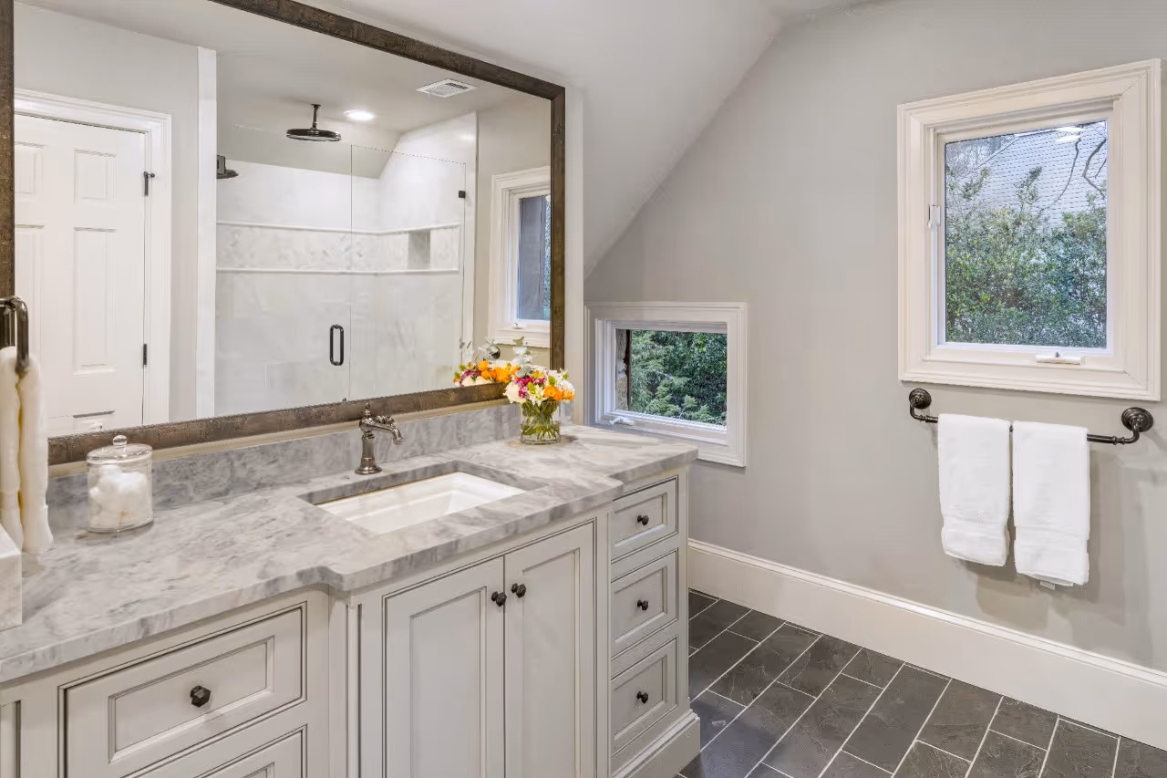 Bathroom with marble countertop and with cabinets vanity