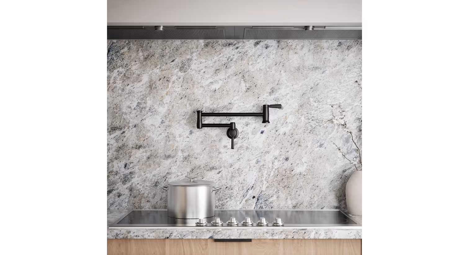A kitchen with a stainless steel pot on a stove