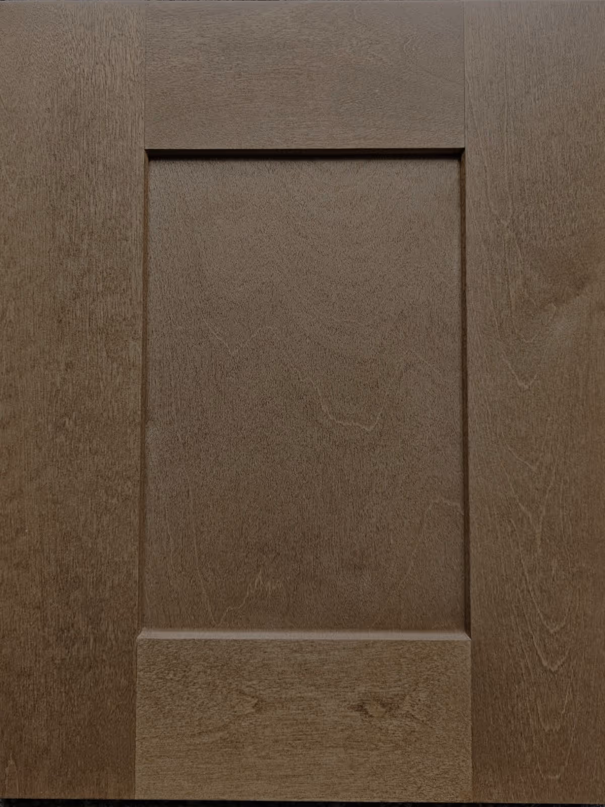 A spacious kitchen featuring a large island with a marble countertop, dark wooden cabinets, and a gas range. Natural light enters through a window, illuminating the room's modern appliances and neutral color scheme.