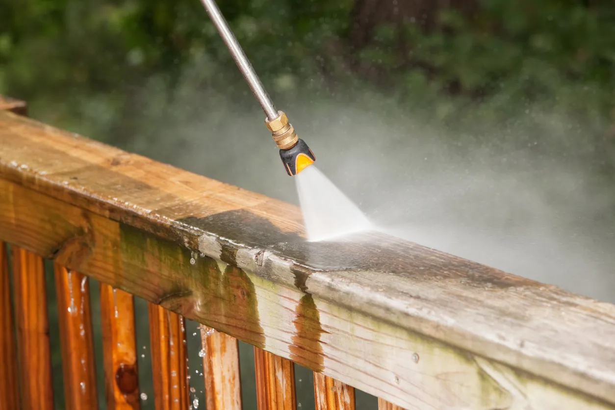 A wooden deck that is being pressure washed