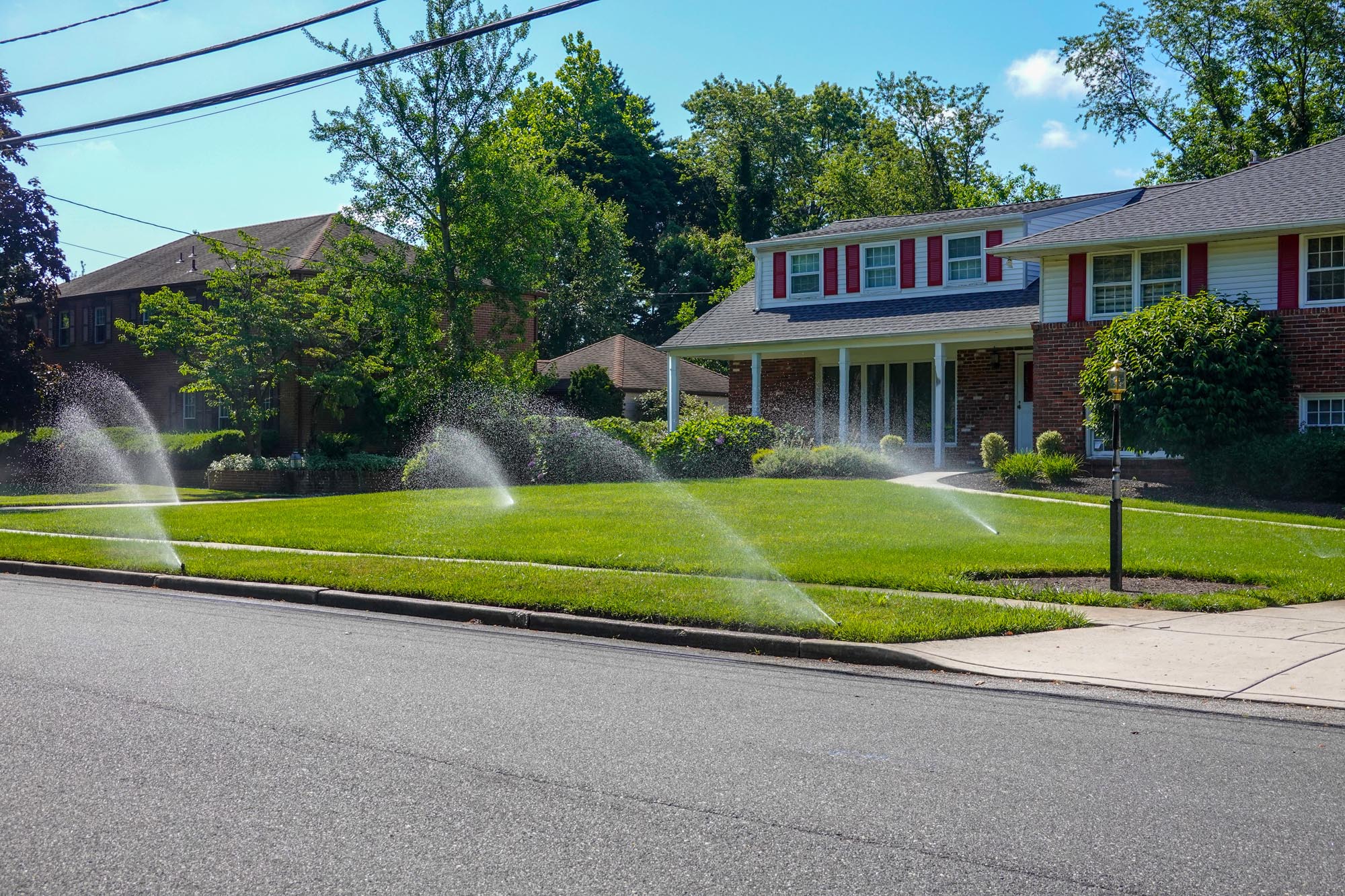green lawn sprinkler spraying water closeup