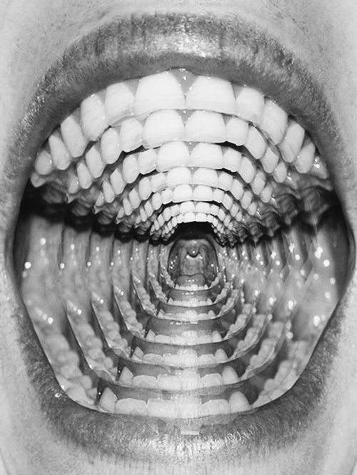 Black and white photo of an open mouth with a repeated, tunnel-like effect showing multiple layers of teeth and throat.