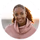 Smiling woman with brown skin and curly hair wearing a pink sweater.