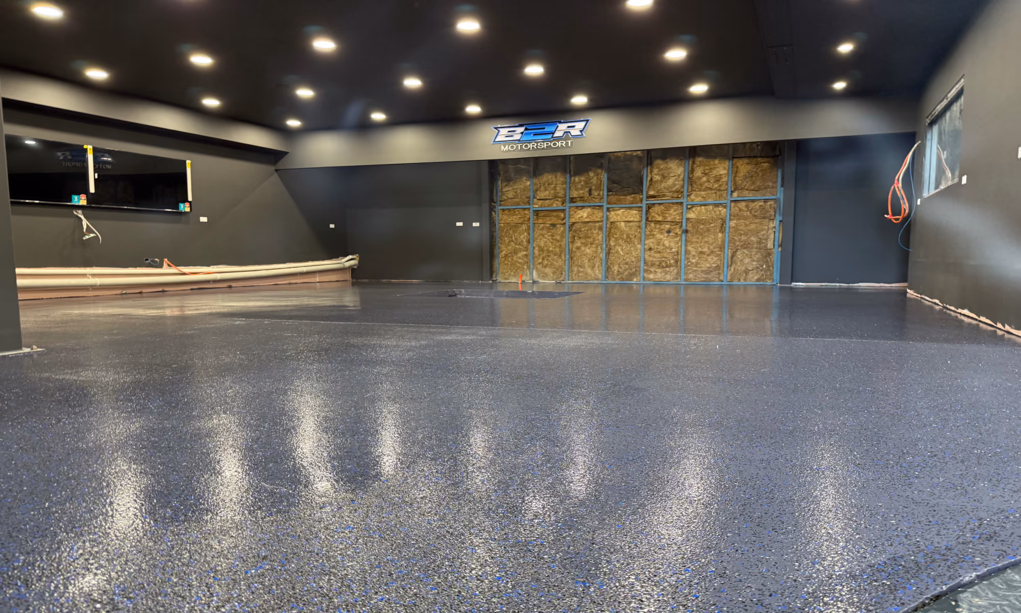 Completed custom flake epoxy workshop and showroom floor at B2R Motorsport in Ingleburn NSW