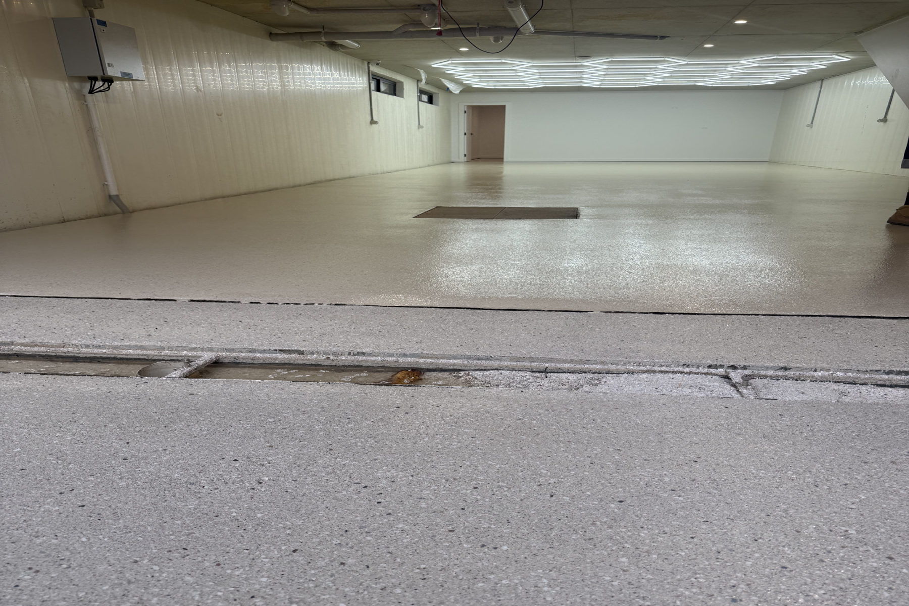Seamless Eggshell epoxy flake floor providing a clean vehicle parking area beneath the duplex development