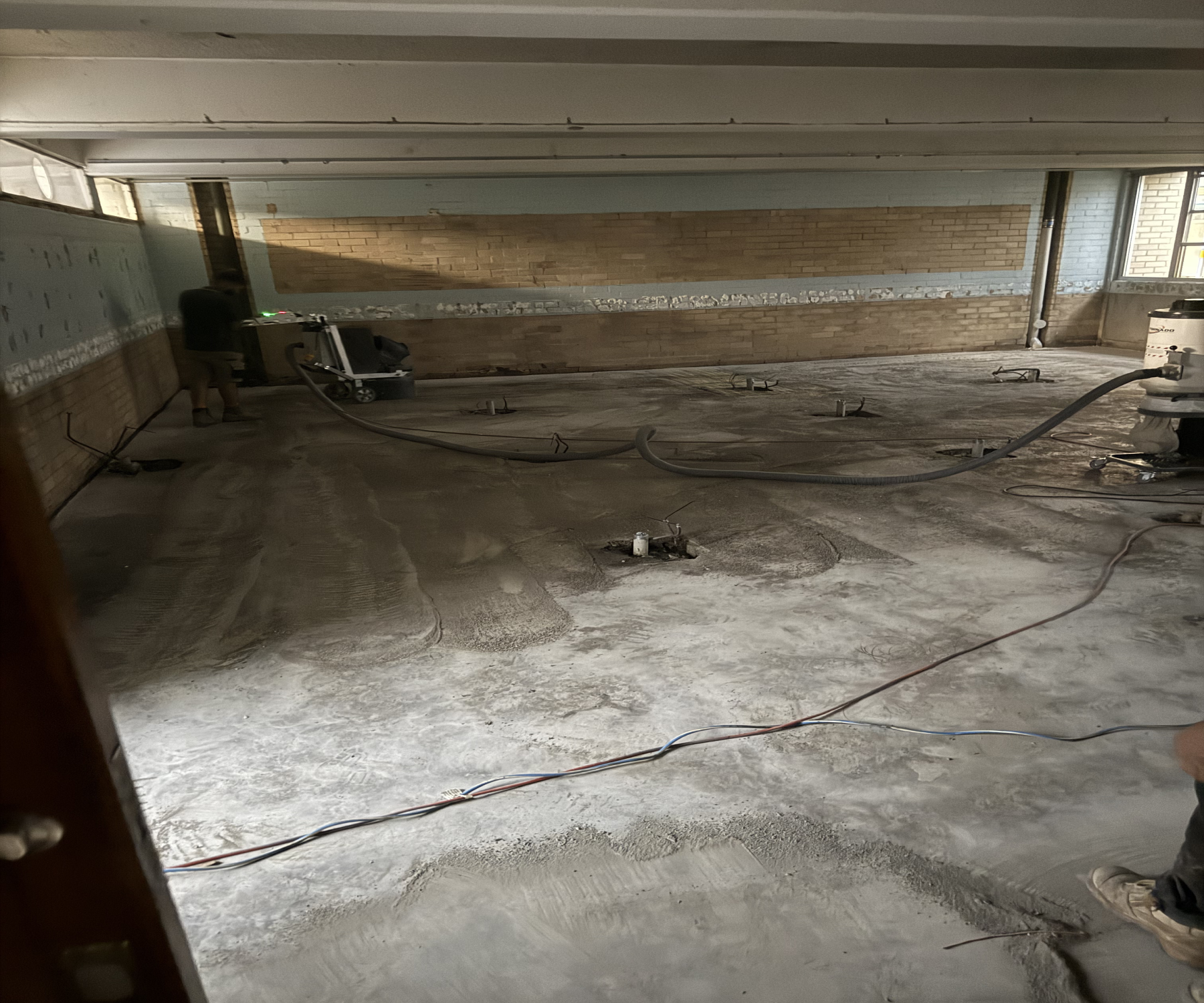 160 kg Tornado concrete grinder removing long-standing floor glue inside the Windsor school