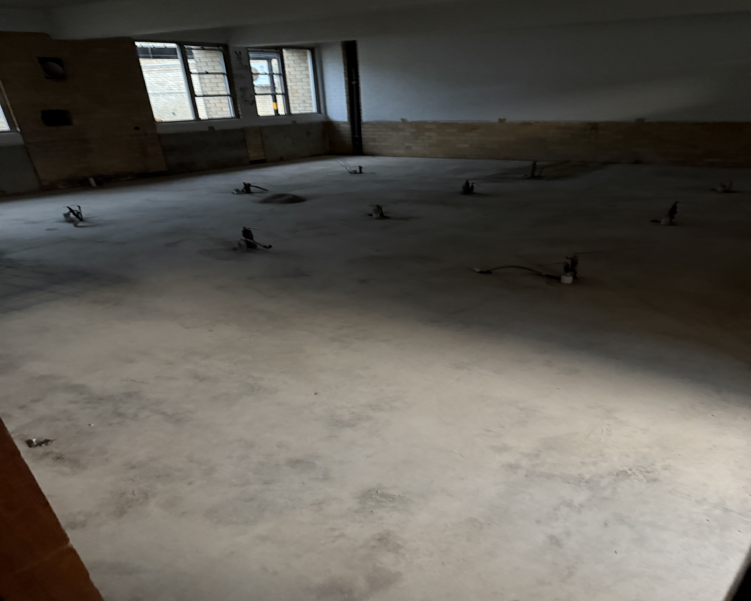 School concrete floor after the bulk adhesive layer was removed with PCD tooling