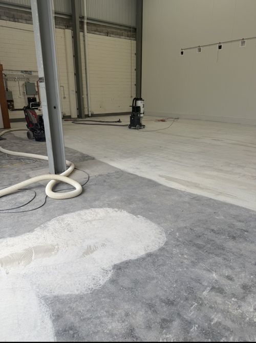 Commercial grinders and industrial dust extractors preparing the food warehouse concrete floor