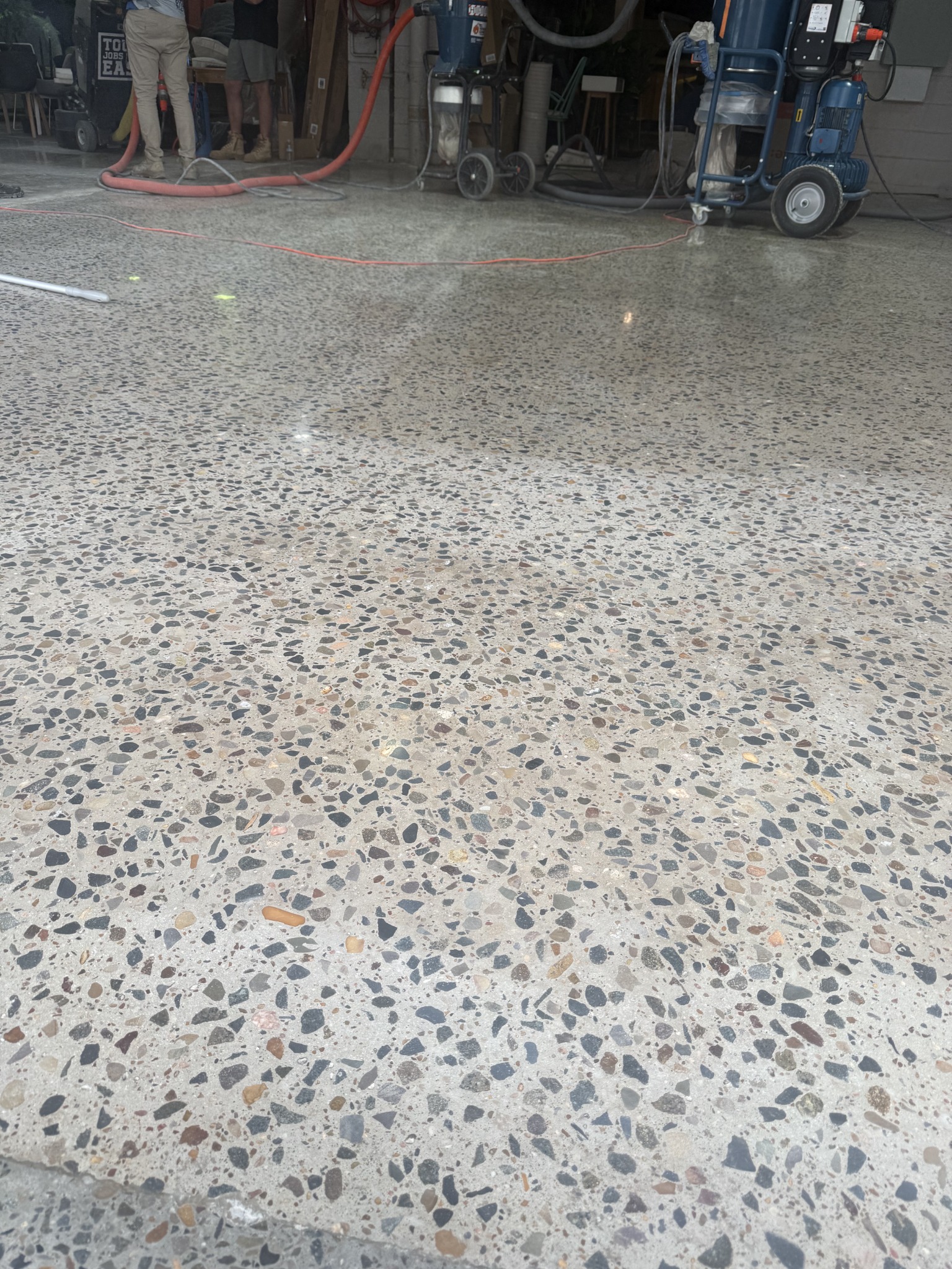 Completed high-gloss polished concrete closely matched to the existing 3000 grit finish