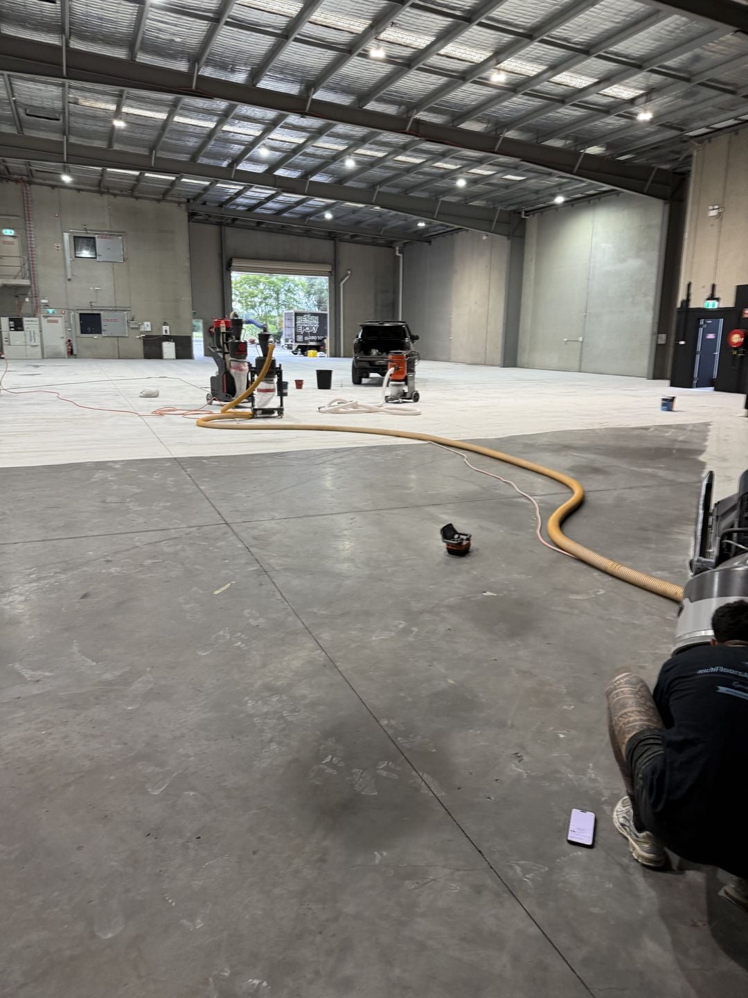 Husqvarna PG 6 DR grinding an adjoining section of the warehouse concrete floor
