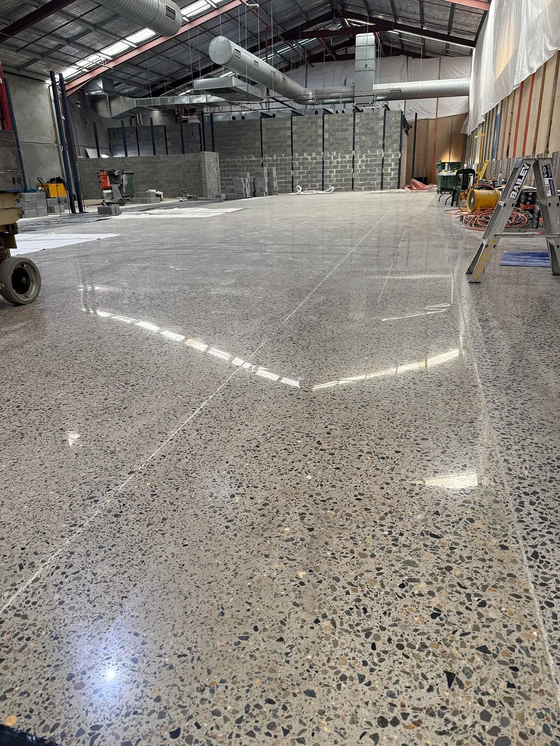 Completed 800-grit polished-concrete floor for a new retail store at Sydney Outlet Village