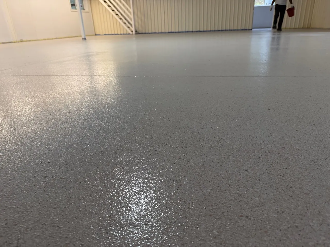 Close view of the community hall's decorative flake floor texture and reflective surface.
