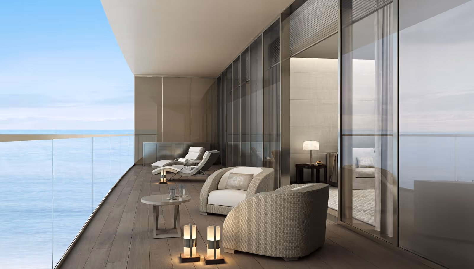 A composite deck balcony with a glass railing overlooking the ocean