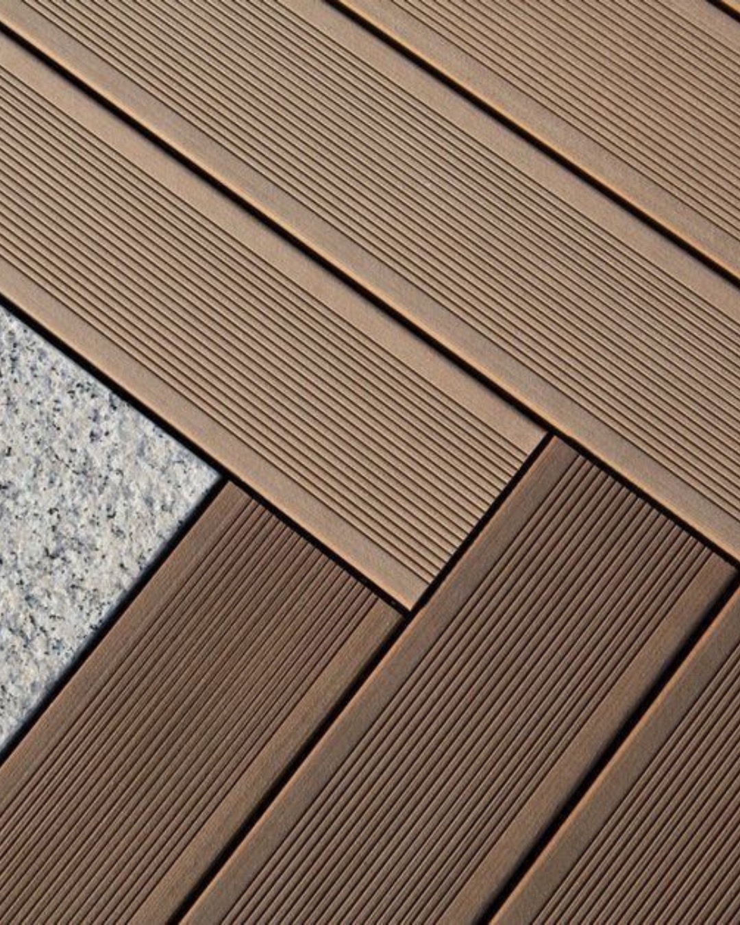 Junction between a Tarimatec deck and a stone surround, showing the finished board edge