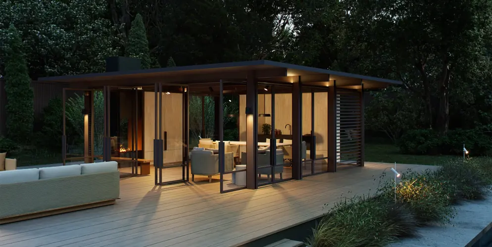 Architectural glass pavilion on a Tarimatec composite deck at dusk