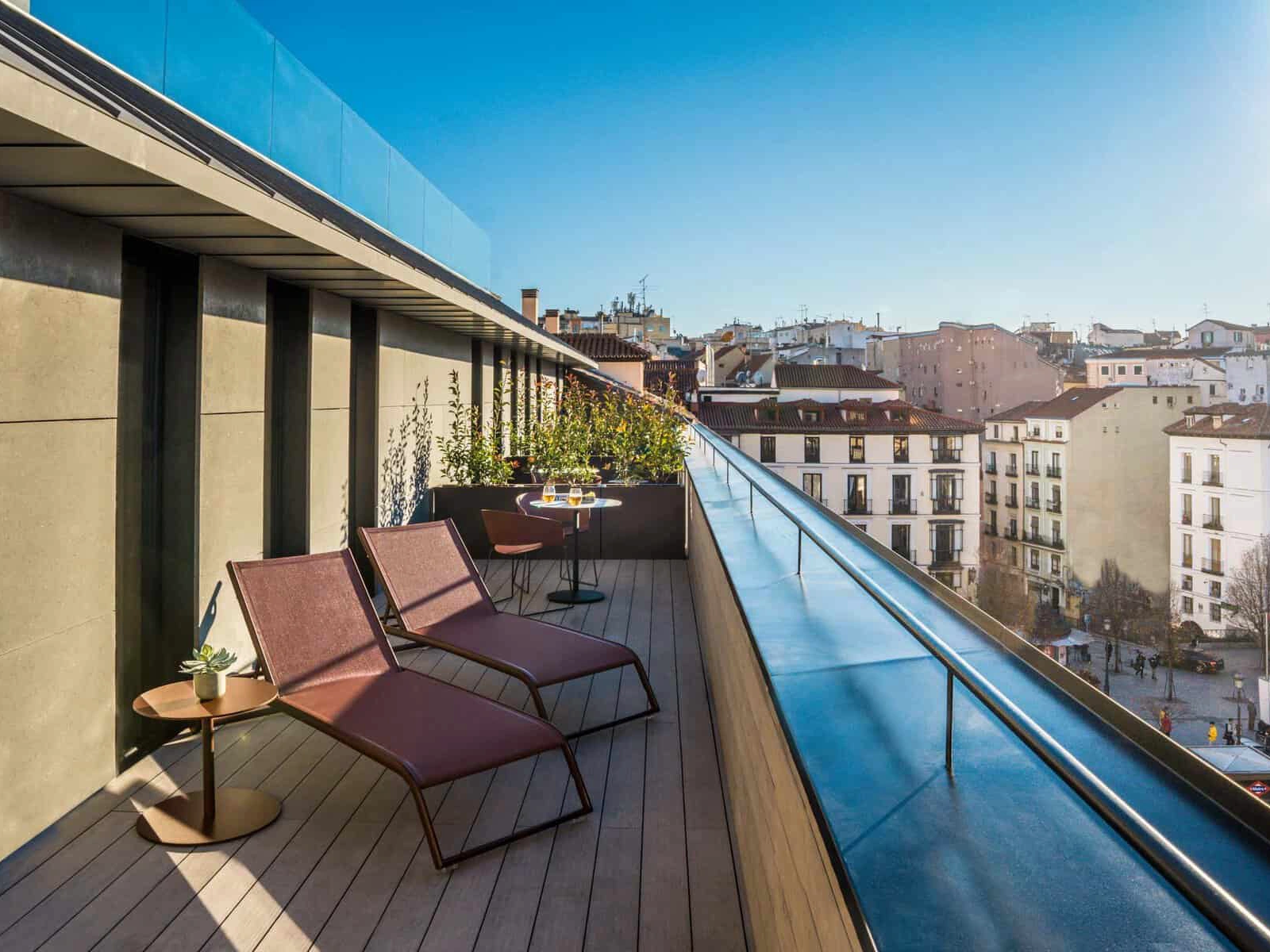 A rooftop terrace at Ocean Drive Madrid, decked in warm composite boards over the city