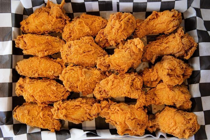 A large plate of 18 double-battered crispy chicken wings.