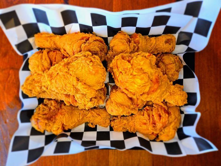 A large plate of 10 double-battered chicken drumsticks.