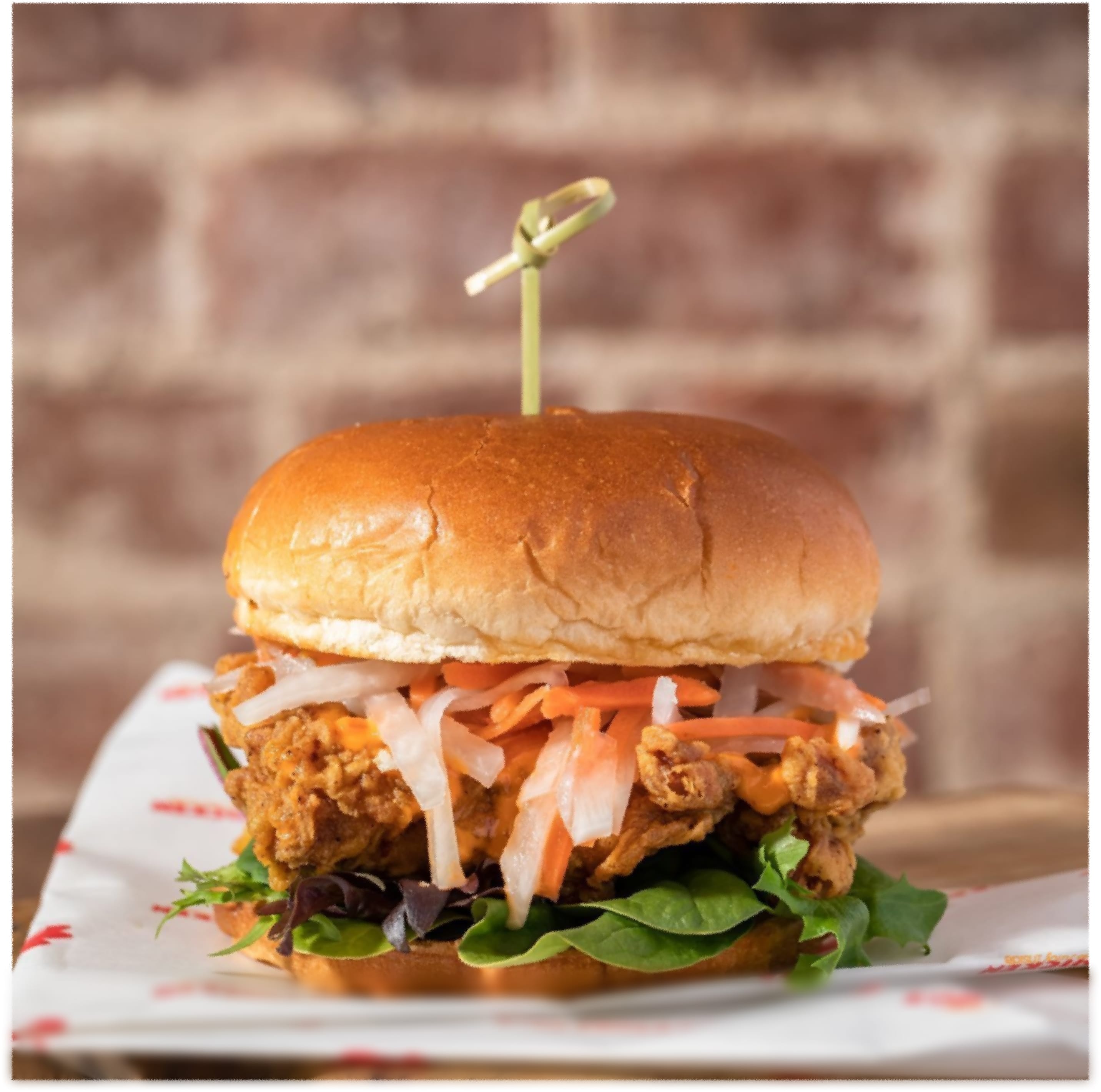A Vietnamese-style fried chicken sandwich with pickled vegetables and spicy mayo.