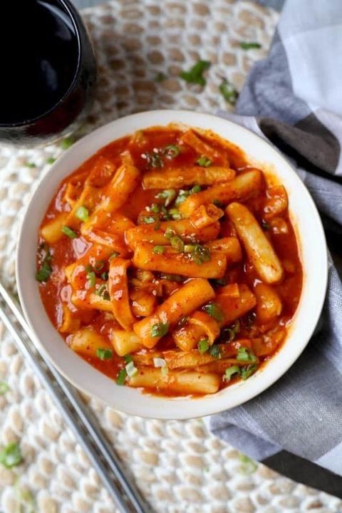A serving of spicy Korean tteokbokki rice cakes in gochujang sauce.