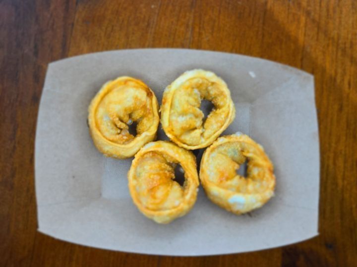 A serving of 4 crispy kimchi mandu dumplings.