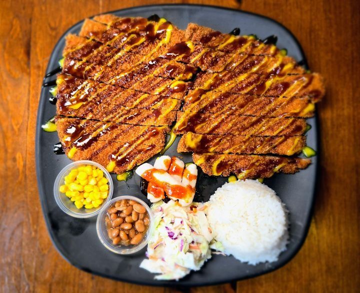A serving of panko-breaded pork cutlet with white rice and shredded cabbage, Korean style.