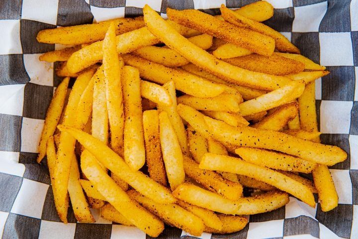 A serving of extra-crispy Cajun seasoned fries.