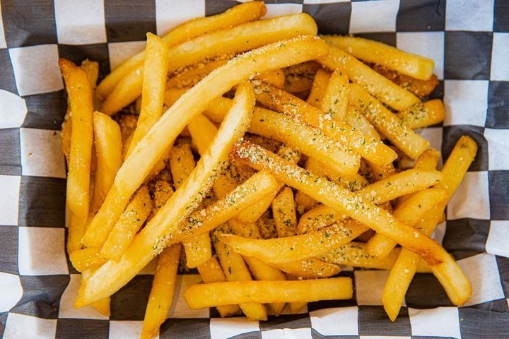 A serving of extra-crispy fries with truffle oil and parmesan cheese.