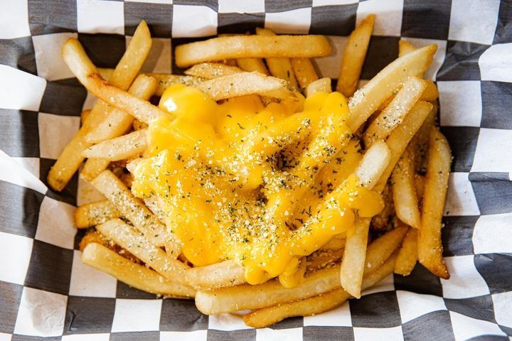 A serving of extra-crispy fries smothered in nacho cheese.