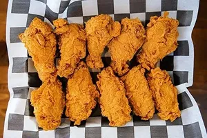 A plate of 10 double-battered crispy chicken wings.
