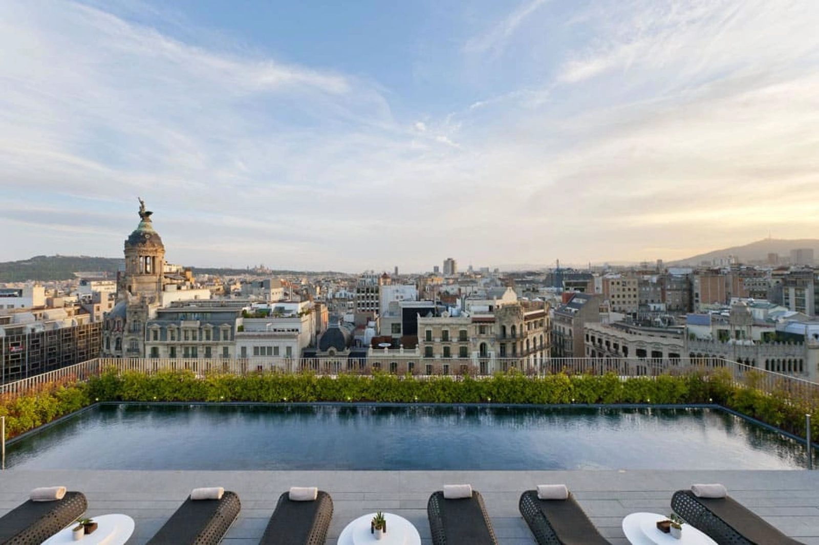 The rooftop pool deck at Mandarin Oriental Barcelona above the city