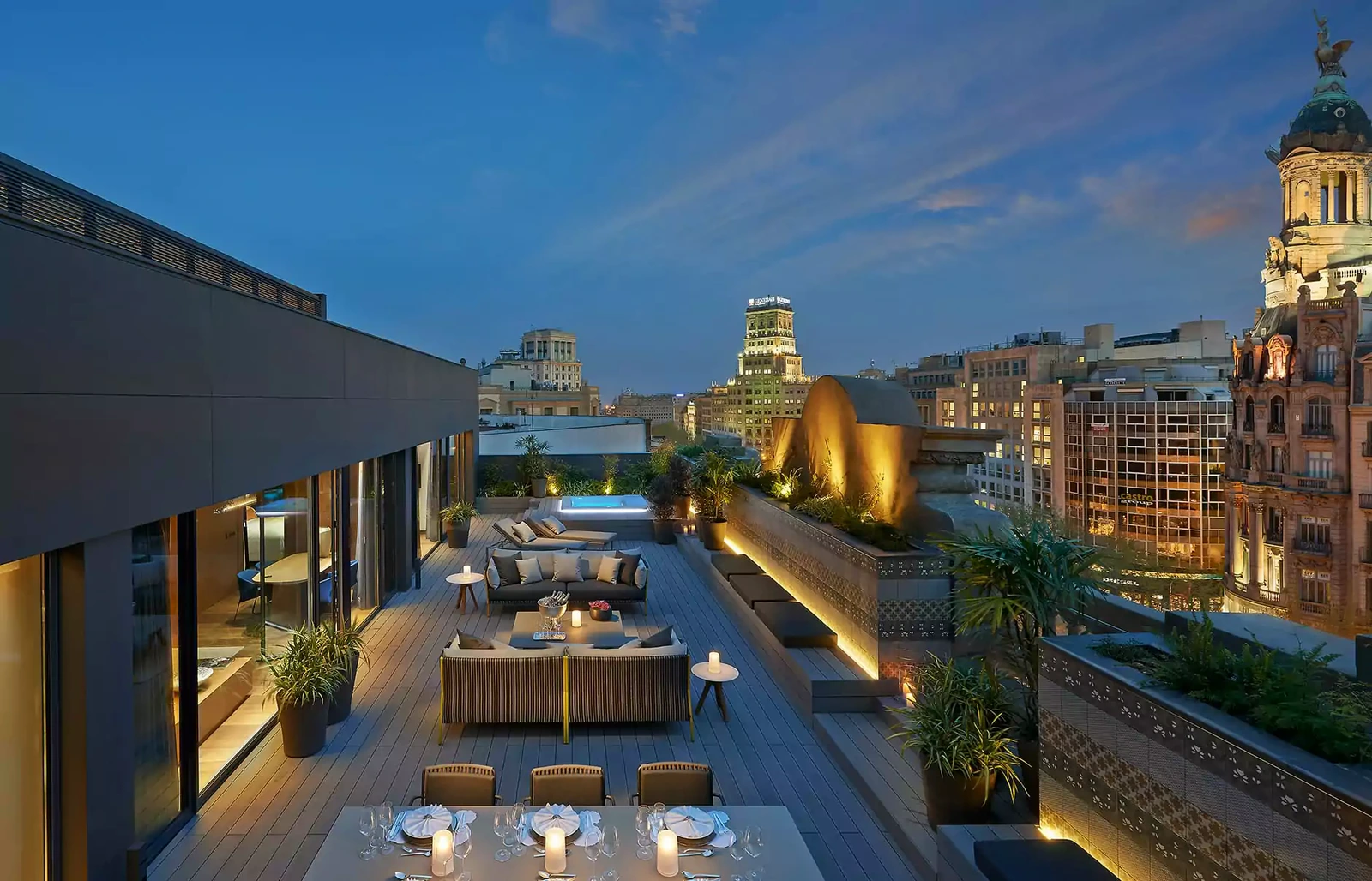 A suite terrace at Mandarin Oriental Barcelona overlooking Passeig de Gracia at night