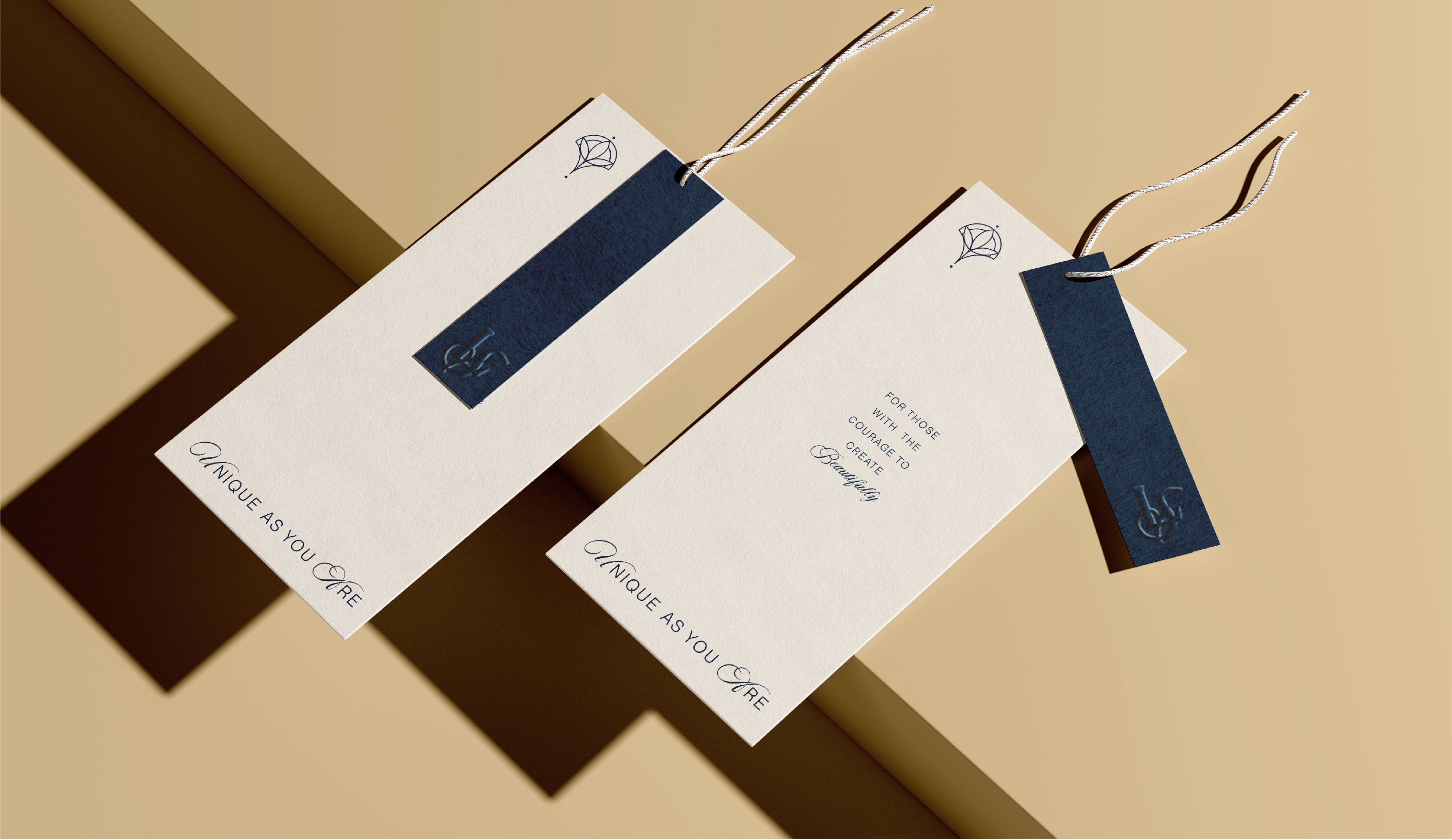 mage of two clothing tags demonstrating a consistent brand identity. The tags feature a minimalist aesthetic with a small, symbolic logo, a bold blue accent, and the tagline "Unique As You Are," conveying a sense of individuality and quality.