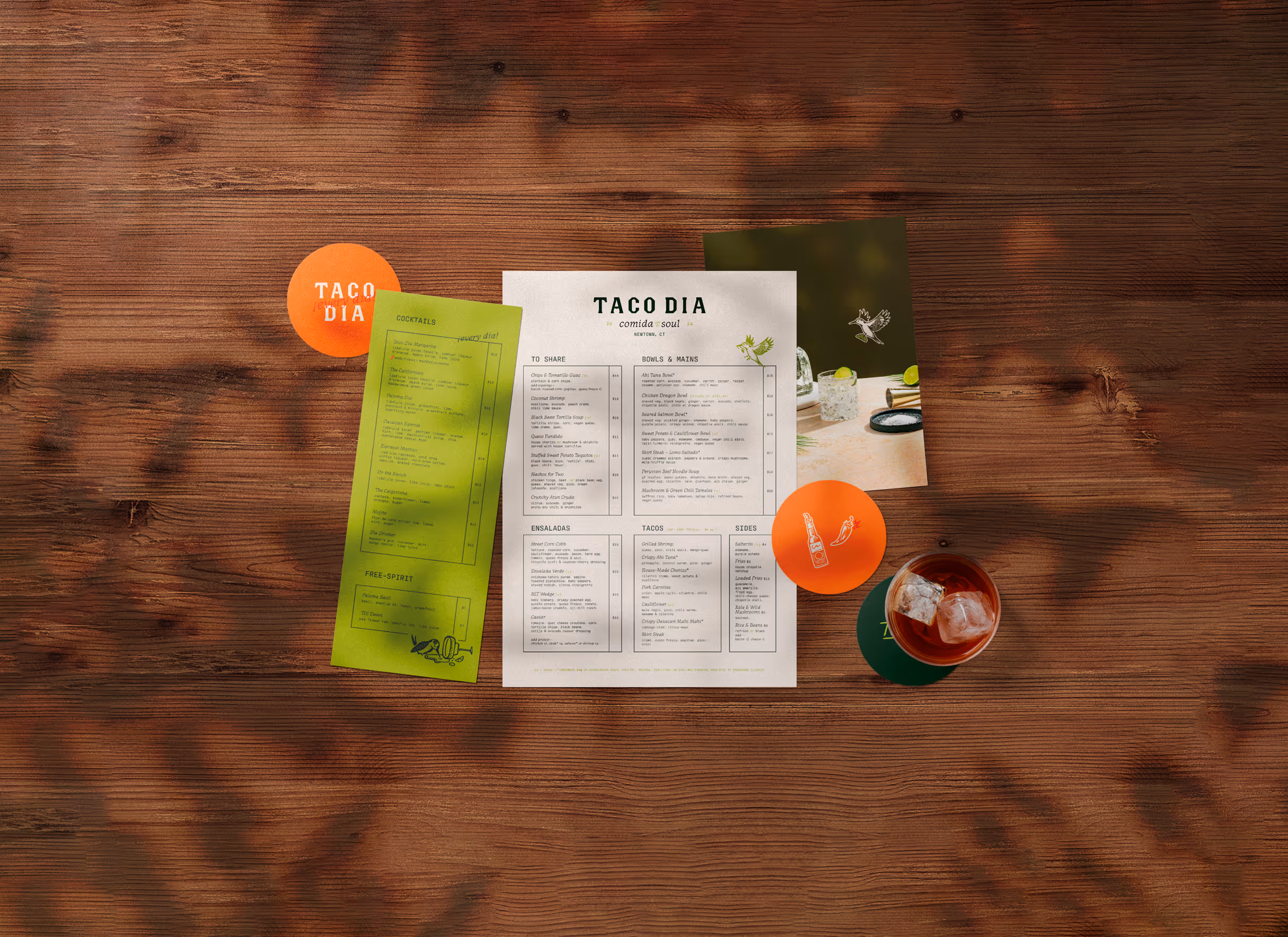 A table layout including various custom designed print items, such as a custom menu, custom postcard, and custom designed coasters for Taco Dia in Newtown, CT.