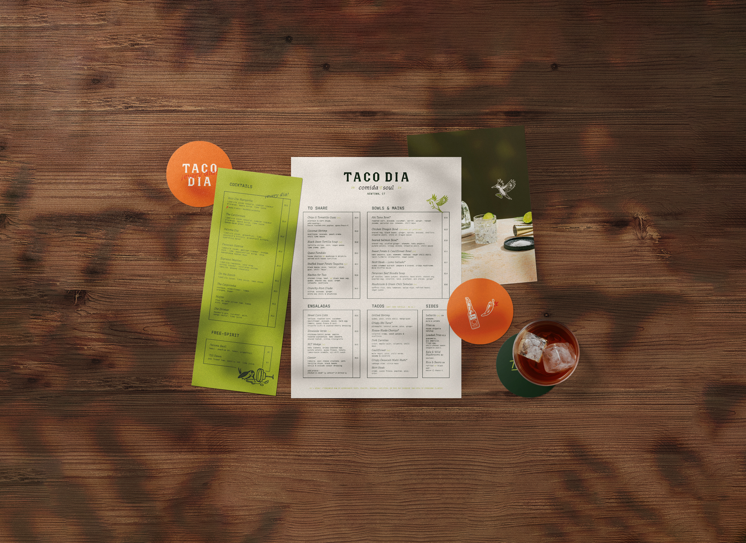 A table layout including various custom designed print items, such as a custom menu, custom postcard, and custom designed coasters for Taco Dia in Newtown, CT.