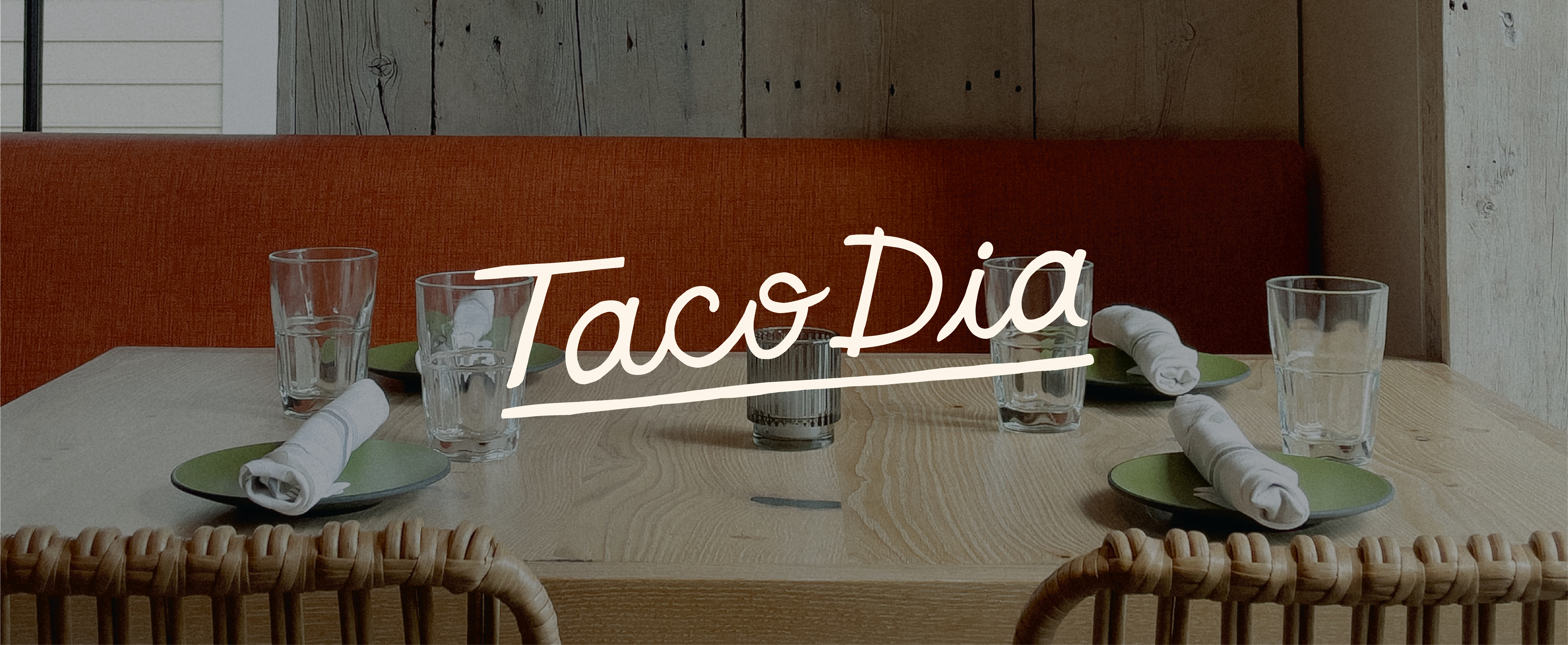 Photo of restaurant seating with custom script logo over top.