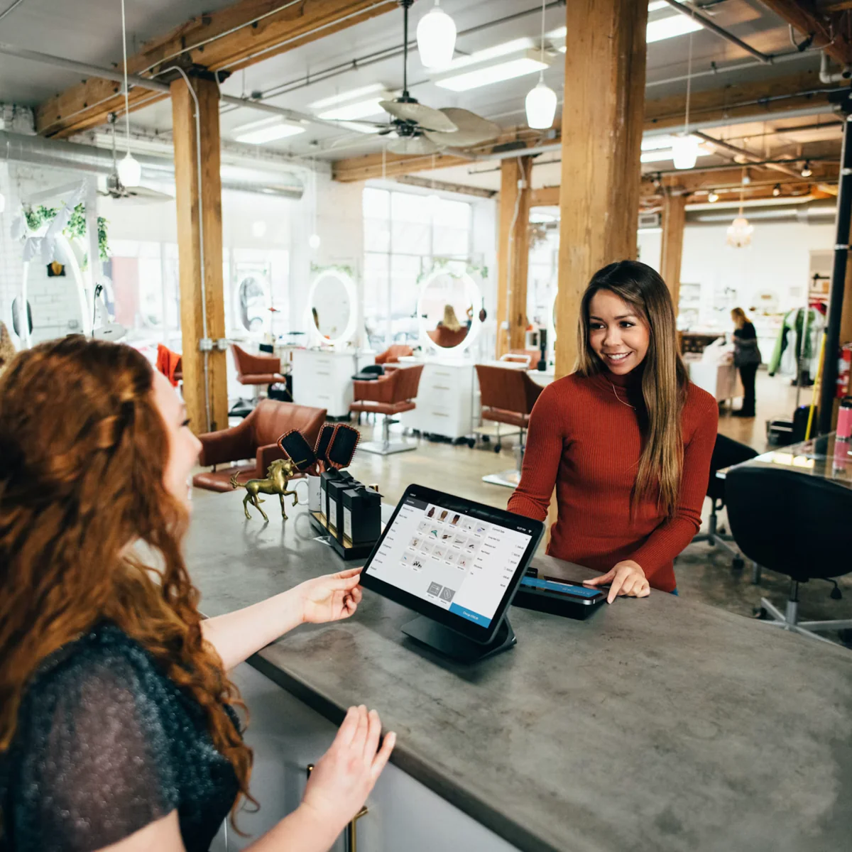 Salon owner helping a customer at reception