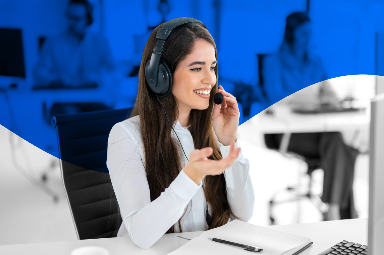Smiling customer service representative wearing headset in blue office