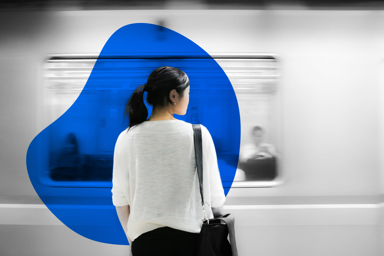 Person standing by train with blue circular graphic element