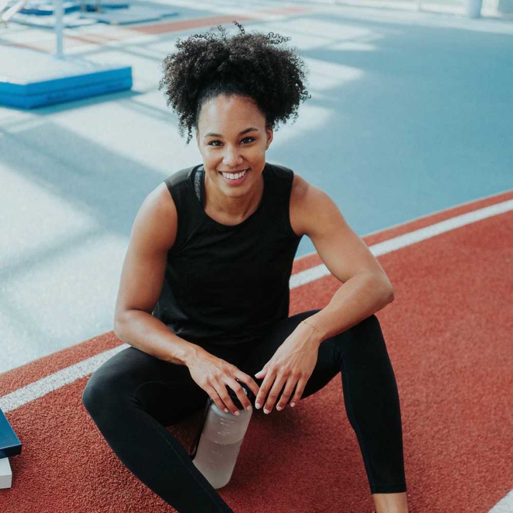 smiling woman sitting on the ground