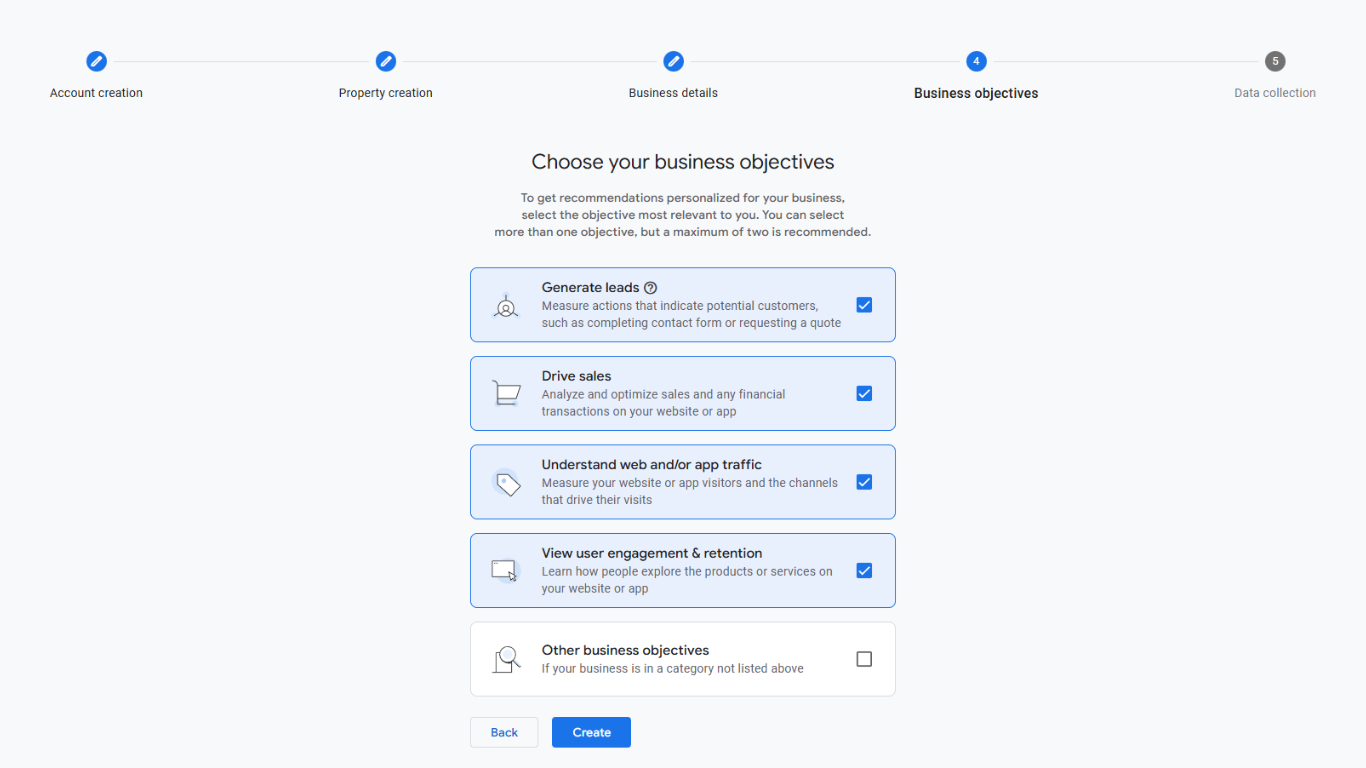 Google Analytics 4 business objectives screen with multiple checkbox options highlighted for selection