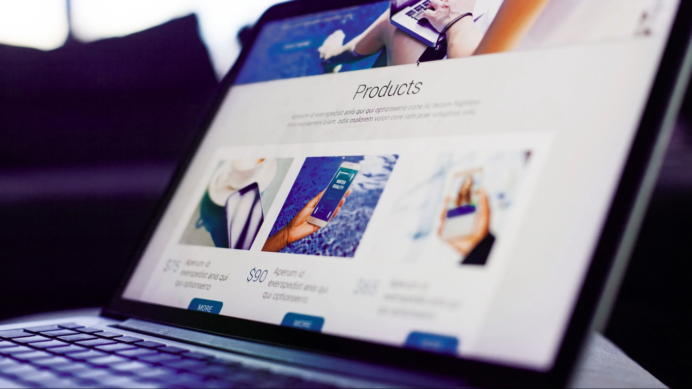 Laptop displaying a generic products page website with placeholder text, lifestyle images, and blue call-to-action buttons
