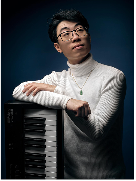 zhi posing with a keyboard