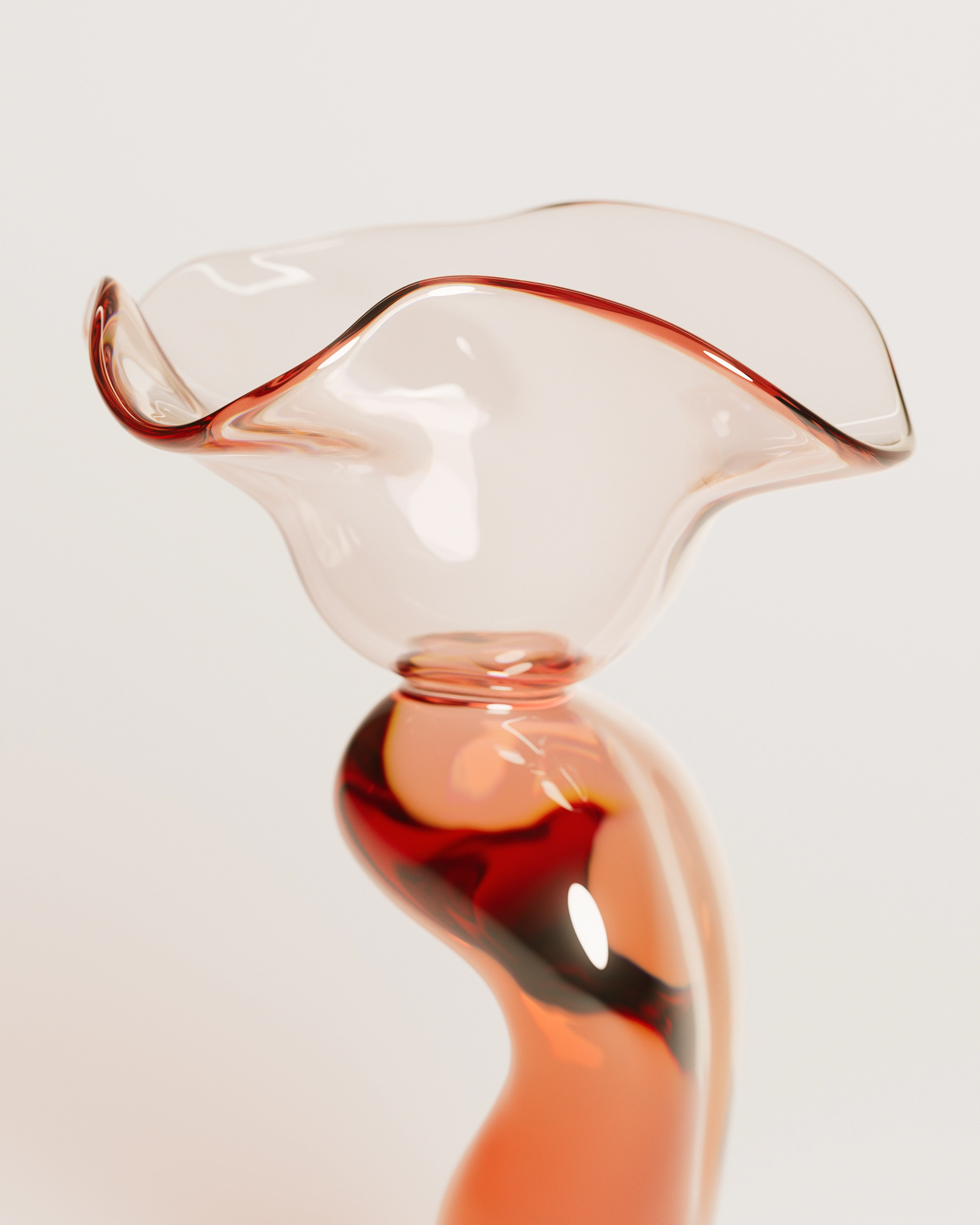Curved transparent glass sculpture with a wavy top and reddish tint on a light background.