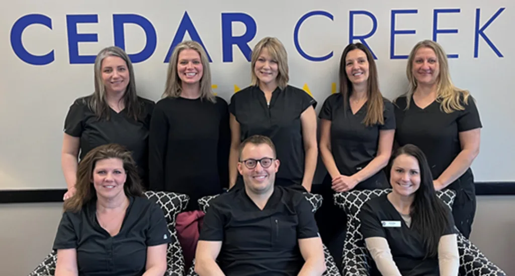 Two dentists taking a selfie with a patient