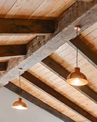 Rustic Beam used as feature truss of ceiling, recycled from wharf and bridge piles and poles. 